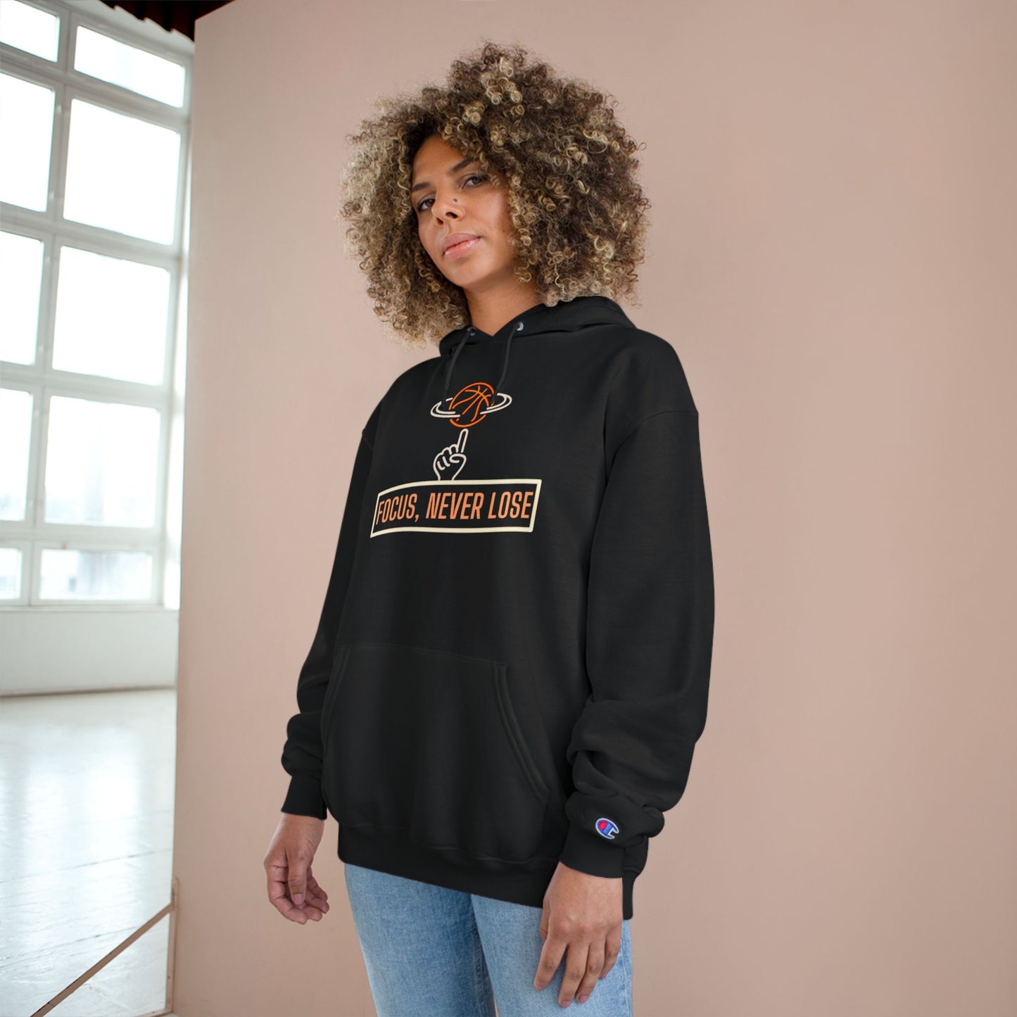 Woman in Neon Basketball Champion Hoodie with bold Focus Never Lose slogan, styled with sporty streetwear.