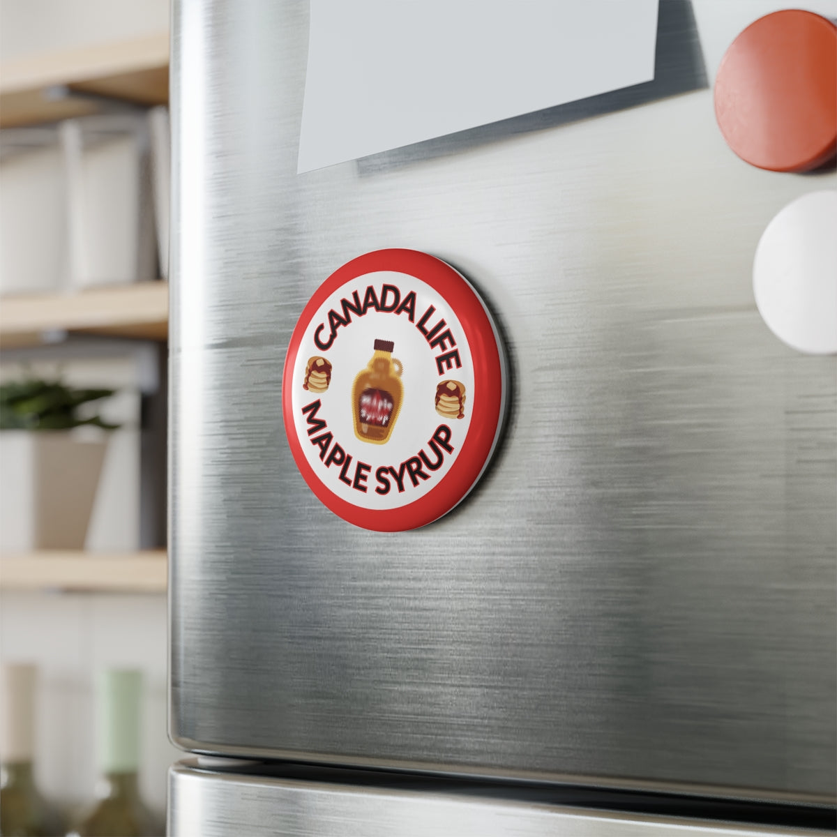 Canada Life Maple Syrup Magnet on refrigerator door – fun Canadian-themed kitchen magnet