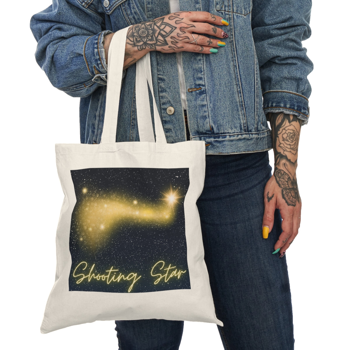 Person holding Golden Shooting Star Tote Bag showing front star design