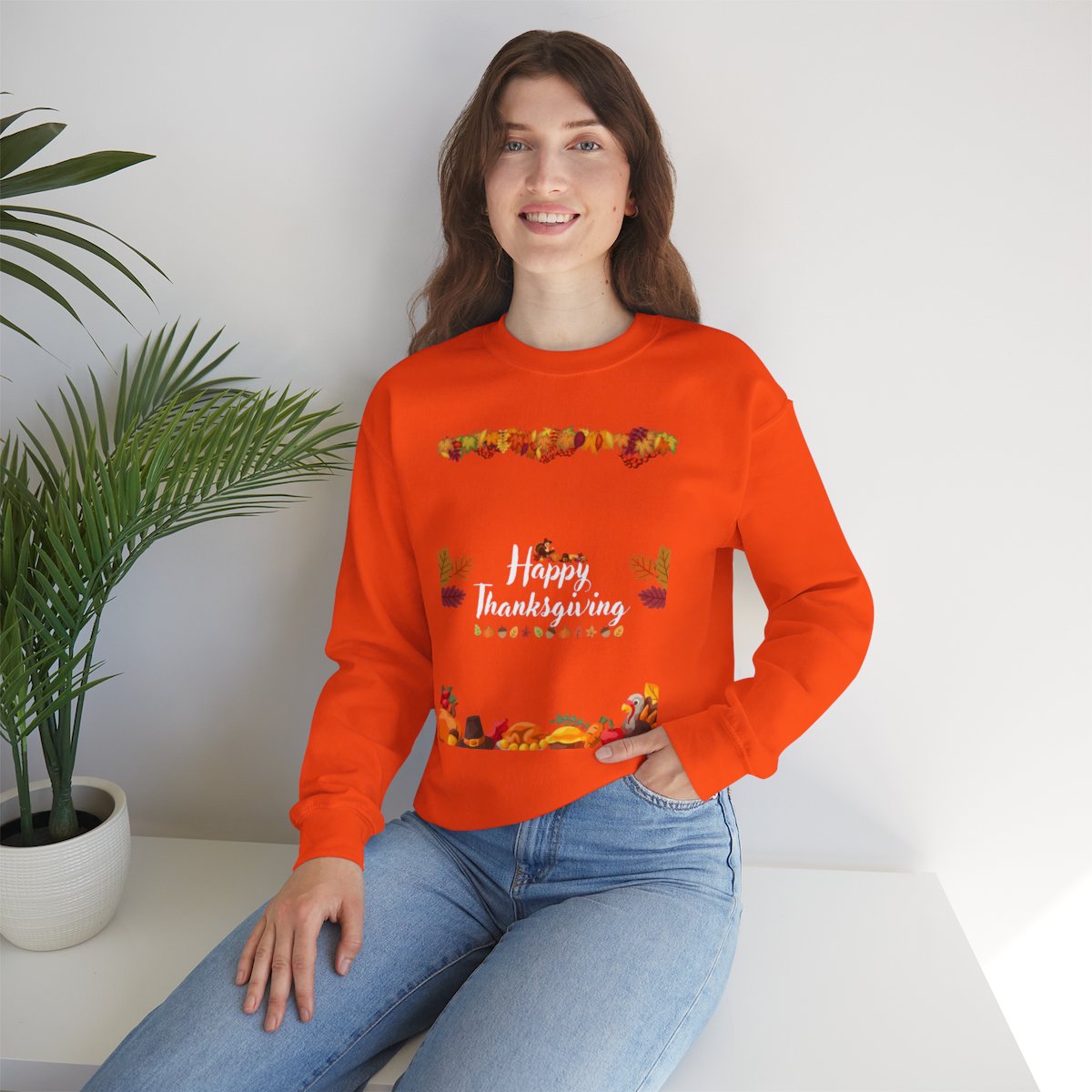 Woman in lifestyle scene wearing thanksgiving crewneck sweatshirt in cozy festive setting