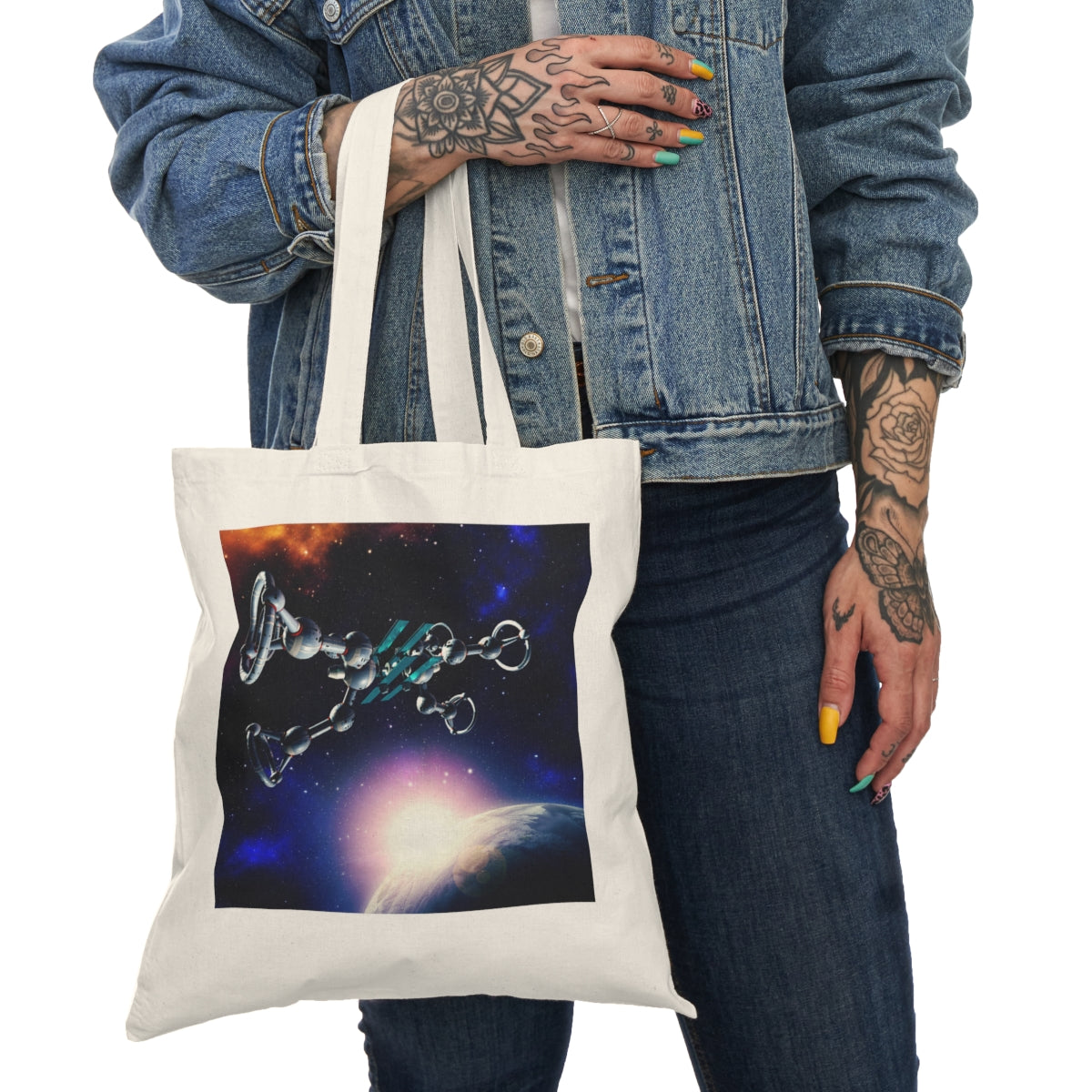 Person holding Galaxy Planet Tote Bag showing front planet graphic