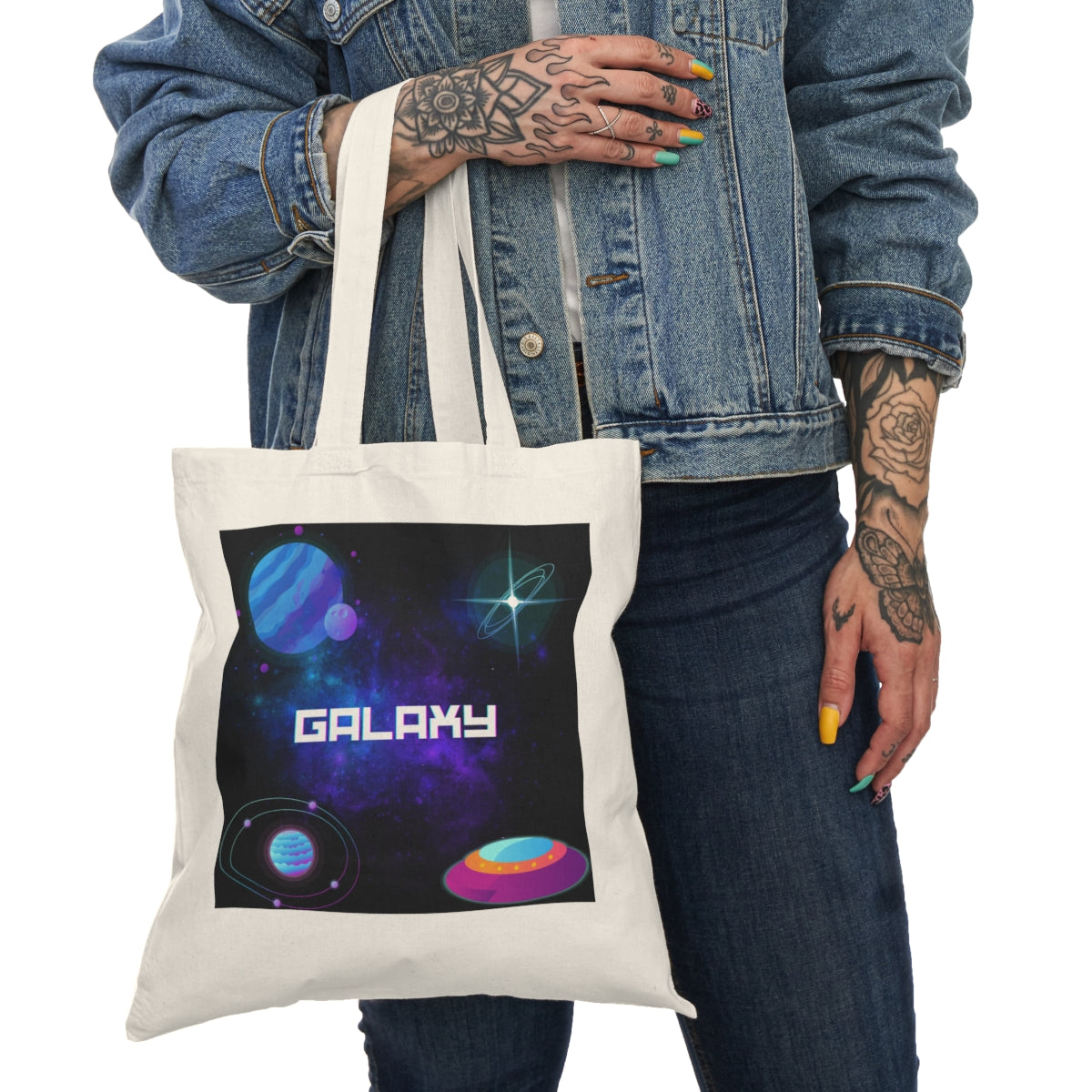 Alternate Front View in Use  Lifestyle image of space galaxy tote bag in use with planetary front graphic
